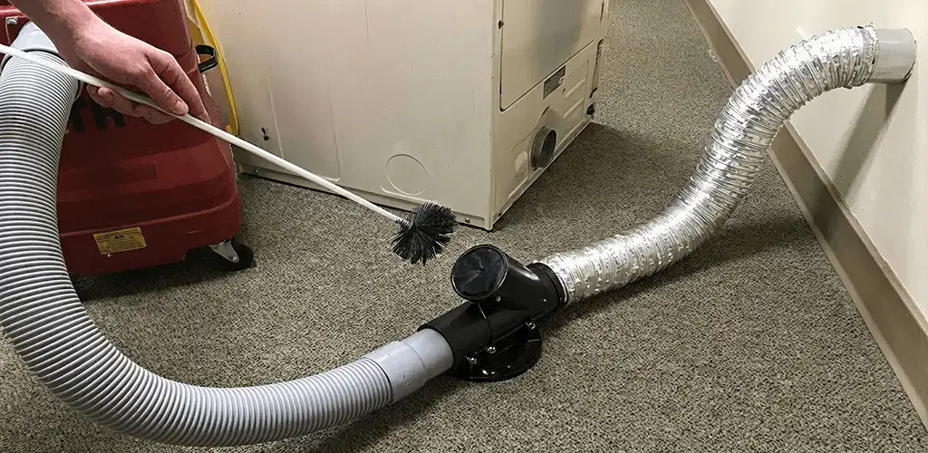 Dryer vent cleaning service removing lint from a dryer duct connection in Sterling Heights, MI