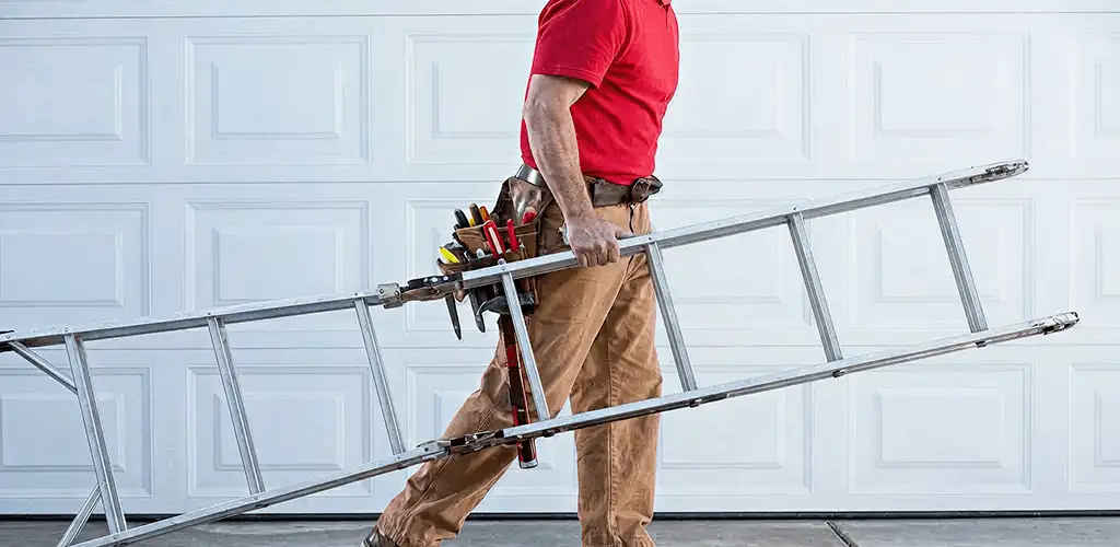 Garage door repair technician arriving with tools and ladder in Sterling Heights, MI