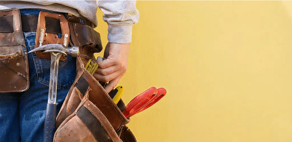 Handyman with tool belt ready for home repairs and maintenance in Sterling Heights, MI