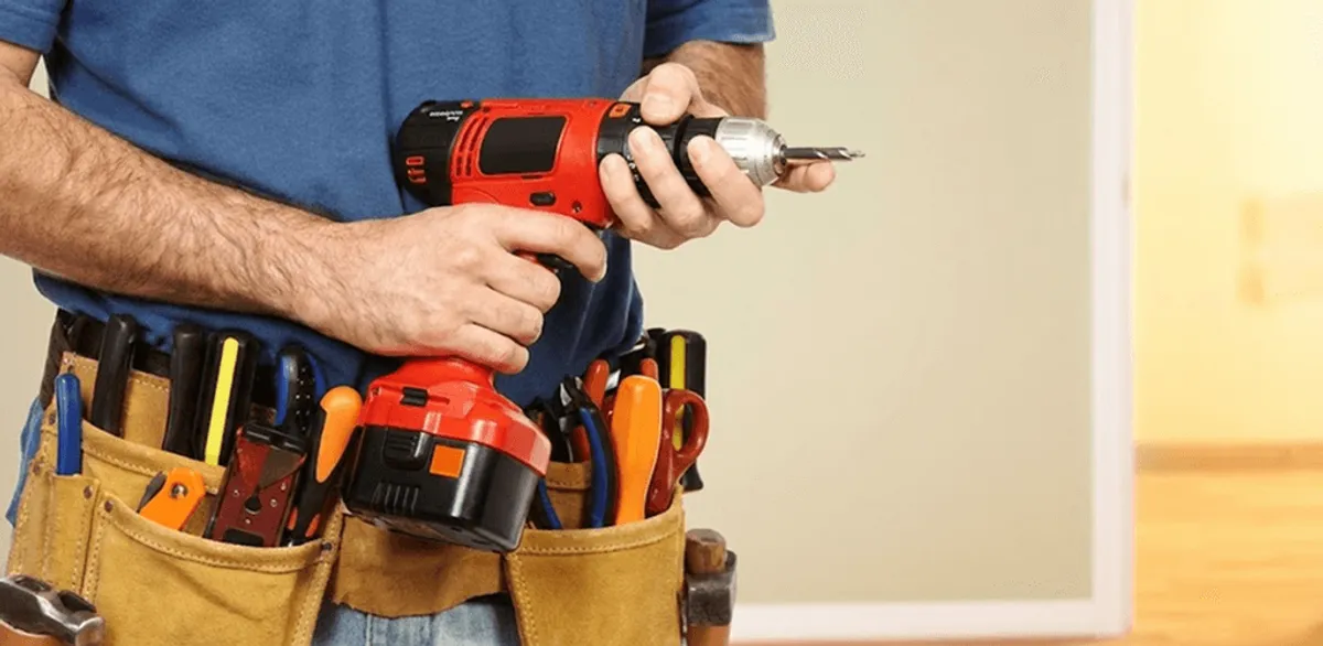 Handyman holding a power drill for home repairs and installations in Sterling Heights, MI