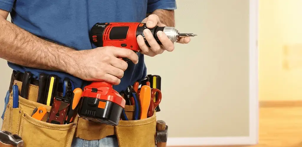 Handyman holding a power drill for home repairs and installations in Sterling Heights, MI