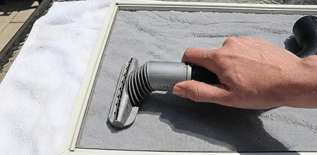 Window screen repair cleaning and fixing a damaged screen mesh in Sterling Heights, MI