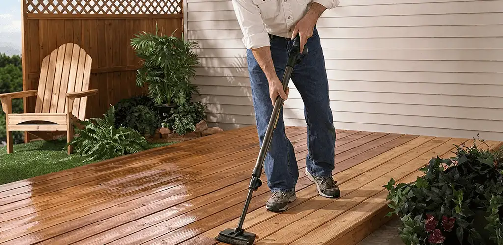 Deck staining service applying stain to a backyard wood deck in Sterling Heights, MI